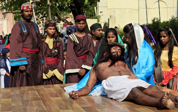 Pessoas encenando a morte de Jesus Cristo, tradição na época de Páscoa.