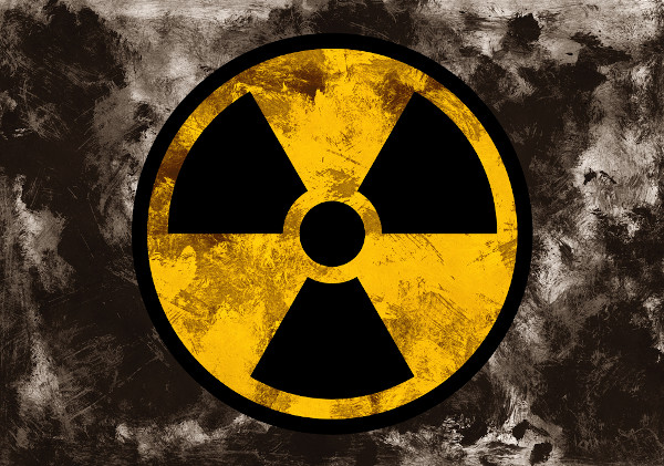 Símbolo da radiação em fundo cinza.