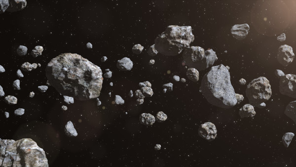 Fragmentos rochosos no espaço, em alusão à origem dos asteroides.